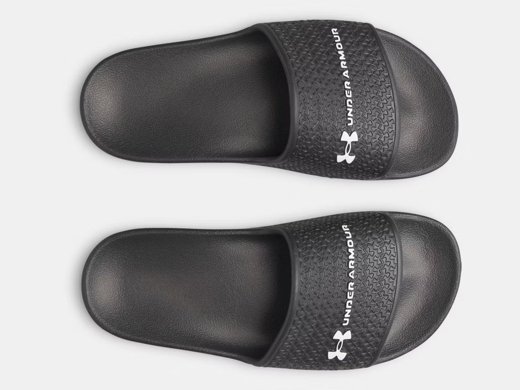 Sandales UA ARMR Shower - Under Armour noires en EVA léger, antidérapantes, pour garçon, vue de dessus.