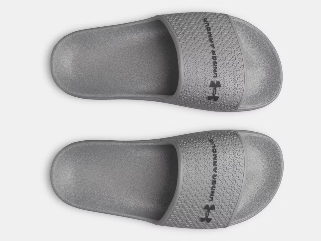 Sandales UA ARMR Shower - Under Armour grises en EVA pour garçon, vue de dessus avec logo noir sur la lanière.