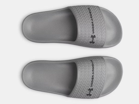 Sandales UA ARMR Shower - Under Armour grises en EVA pour garçon, vue de dessus avec logo noir sur la lanière.