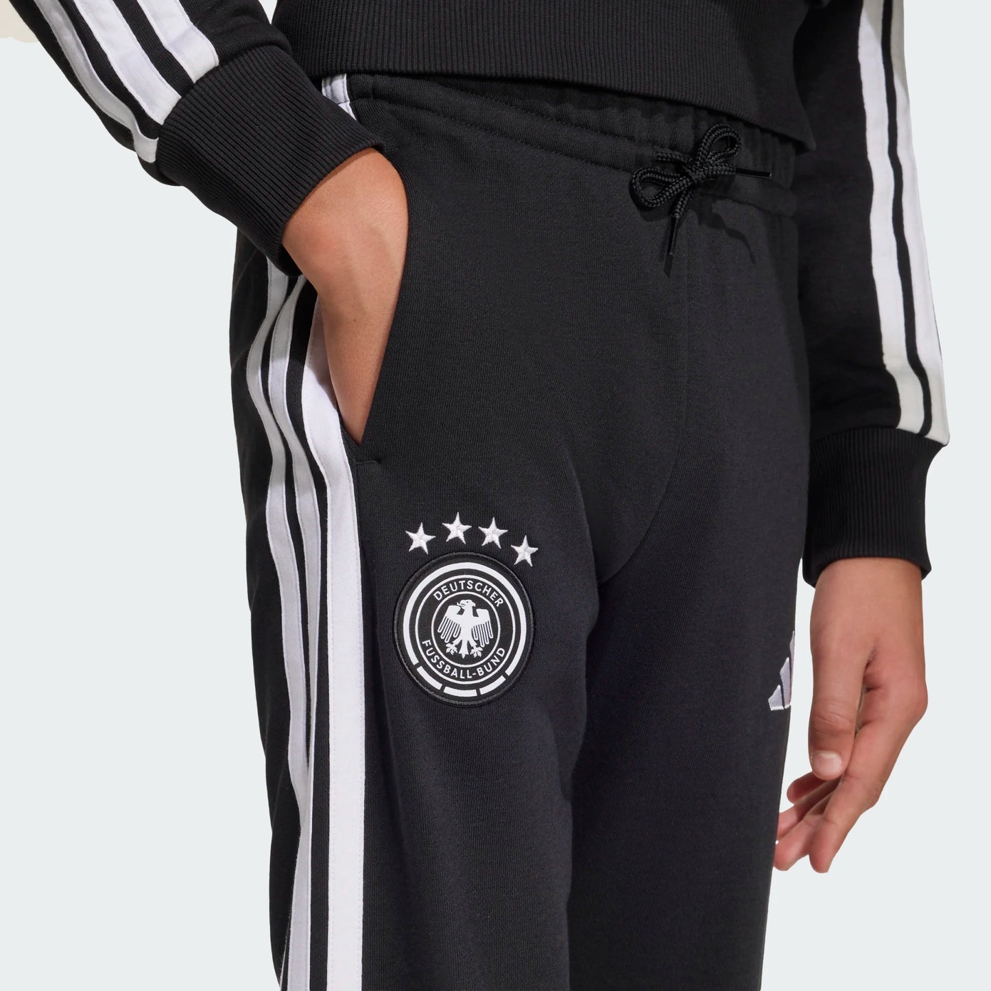 Pantalon Germany - Adidas noir avec bandes blanches latérales, logo équipe Allemagne, taille élastique et cordon, pour enfant, vue de face.