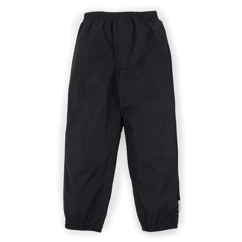Pantalon d'extérieur - Nanö noir en tissu technique, coupe droite avec taille et chevilles élastiquées, vue de face, enfant.