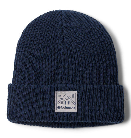 Tuque d'hiver - Columbia en tricot bleu marine avec revers et étiquette logo, vue de face sur fond blanc.