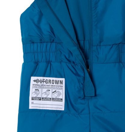 Habit de neige Buga Set - Columbia bleu pétrole en tissu matelassé, vue rapprochée sur fermeture et étiquette ajustable, enfant.
