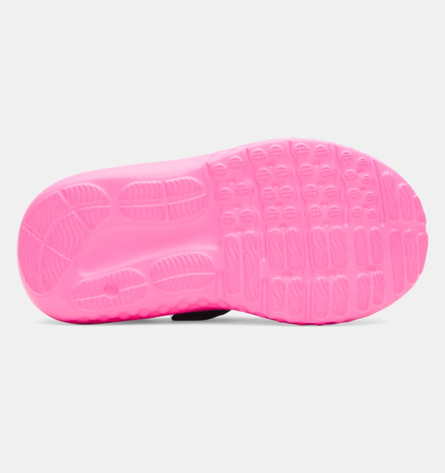 Semelle rose vue de dessous des Espadrilles UA Surge 4 AC - Under Armour pour enfant avec détails antidérapants en caoutchouc