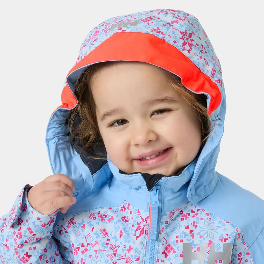 Manteau d'hiver Rider - Helly Hansen bleu clair à motifs géométriques roses et gris avec capuche rouge pour enfant vu de face