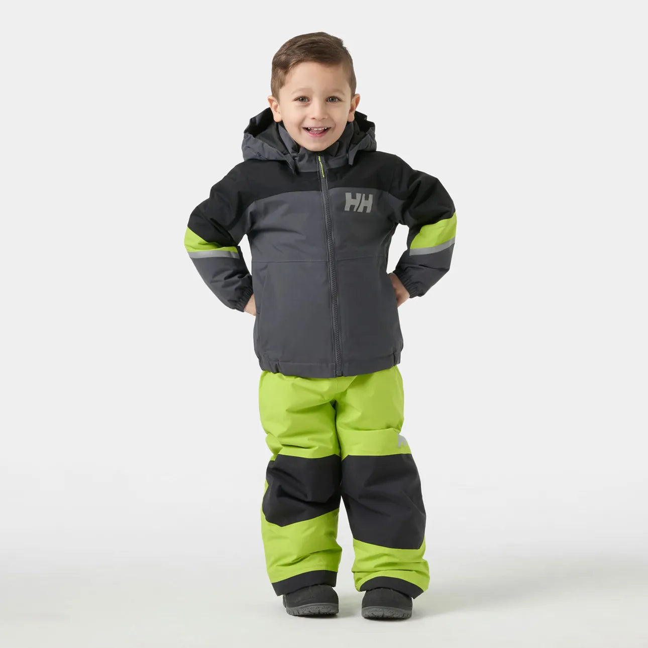 Manteau d'hiver Rider - Helly Hansen gris foncé, noir et vert fluo, coupe enfant, porté sur mannequin garçon, vue de face, tissu imperméable.
