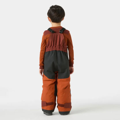 Salopette de neige Rider - Helly Hansen bicolore marron et noir en tissu technique, portée par un enfant, vue de dos.