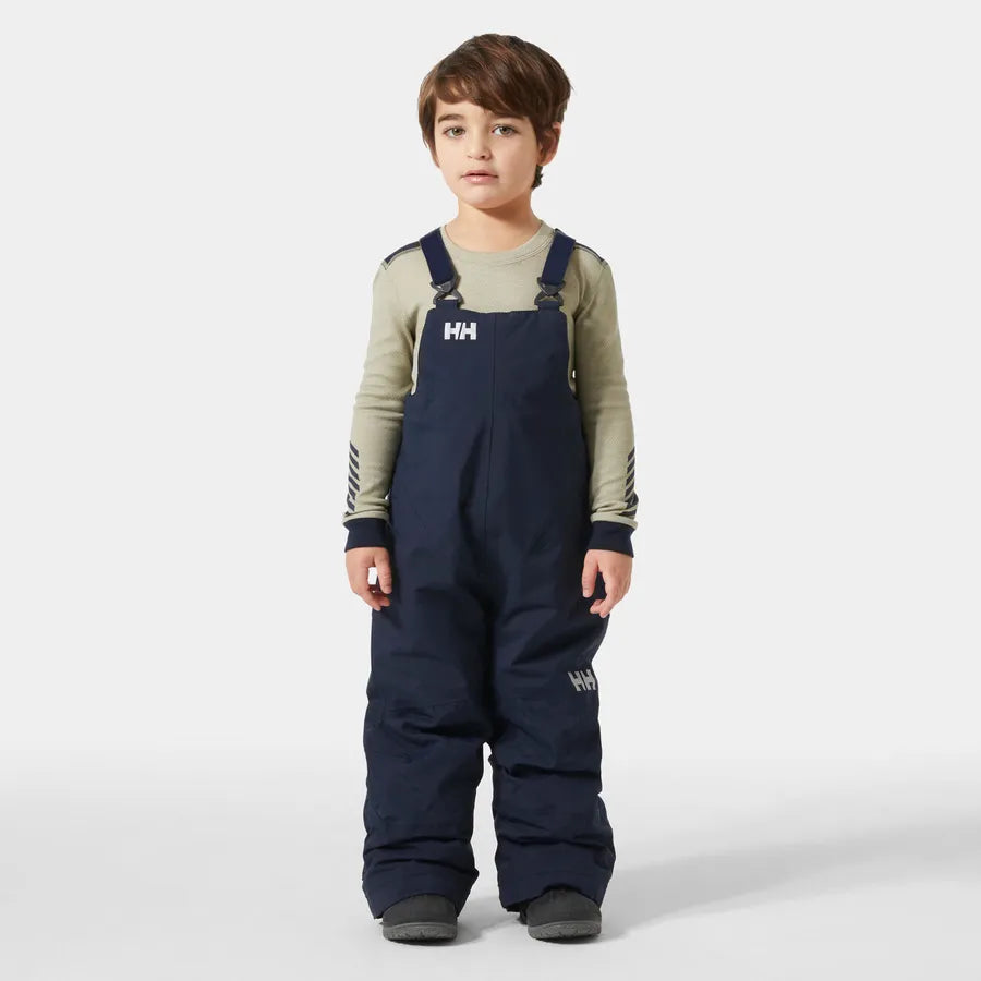 Salopette de neige Rider - Helly Hansen bleu marine portée de face par un garçon avec bretelles réglables