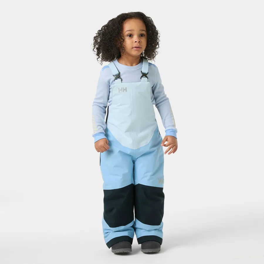 Salopette de neige Rider - Helly Hansen bleu clair et bleu marine portée par une fille vue de face