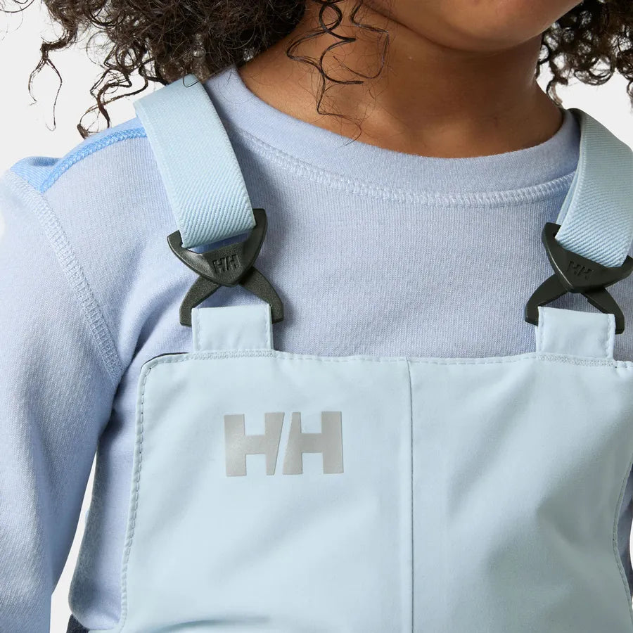Salopette de neige Rider - Helly Hansen bleu clair pour enfant, bretelles ajustables, détail porté de face