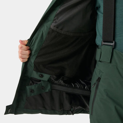 Détail d’une veste vert foncé ouverte, avec doublure en maille noire, boutons-pression et sangle réglable, vue rapprochée