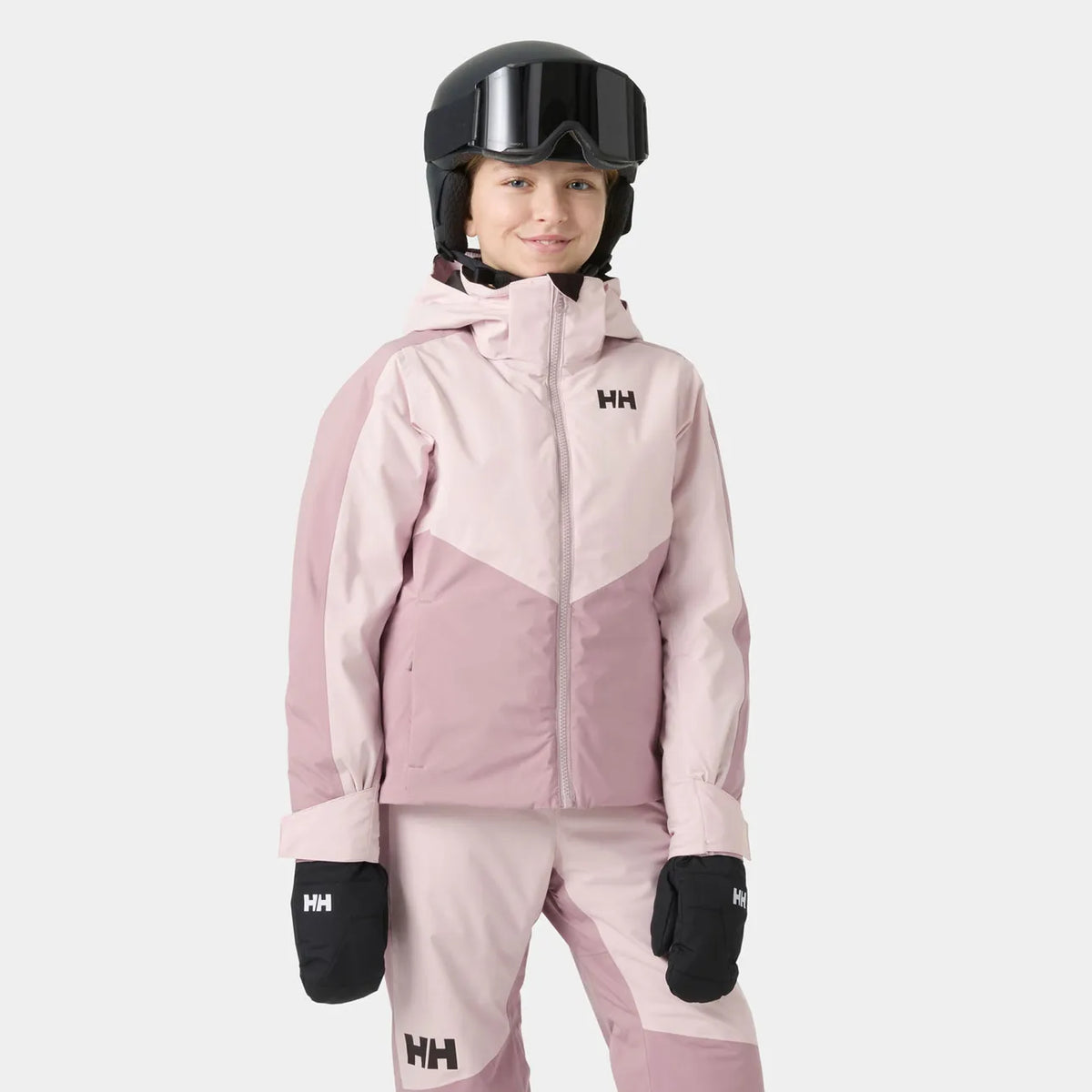 Manteau d'hiver Snowbliss - Helly Hansen rose pour enfant avec capuche portée et vue de face en tenue de ski