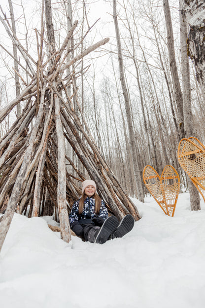 Bottes d'hiver - Acton Cortina noires en cuir synthétique imperméable, fille, vue portée assise dans la neige devant tipi en bois