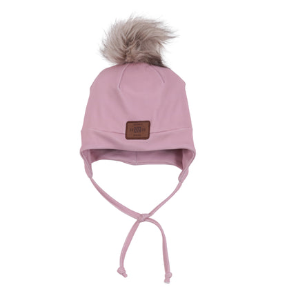 Tuque Mi-Saison - Nanö rose pâle en tissu doux avec doublure, pompon en fausse fourrure, liens sous le menton, pour enfant, vue de face.