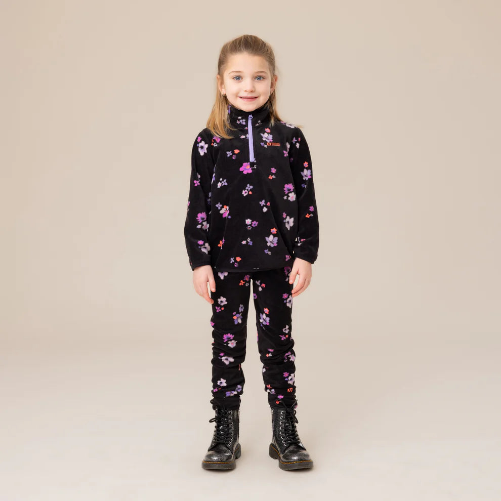 Enfant fille portant un Ensemble Thermal - Nanö noir avec motifs floraux roses et violets, style col zippé, vue de face, porté sur mannequin.