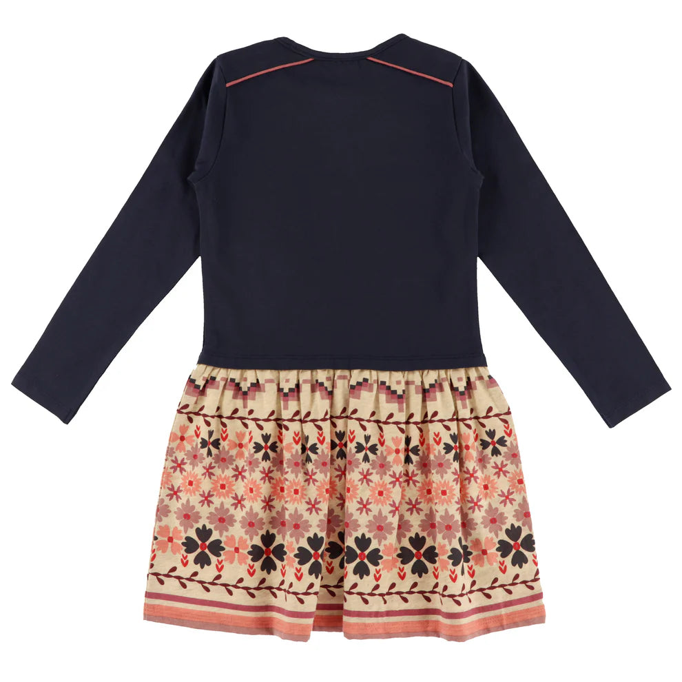 Robe - Nanö pour enfant, manches longues bleu marine, jupe beige à motifs floraux rouges et noirs, vue de dos.