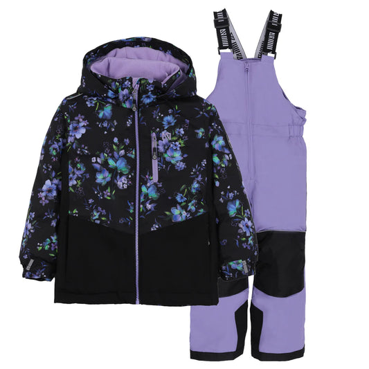 Habit de neige Lara - Nanö noir avec motif floral violet et bleu, pantalon violet avec renforts noirs, ensemble enfant, vue de face sur fond blanc.