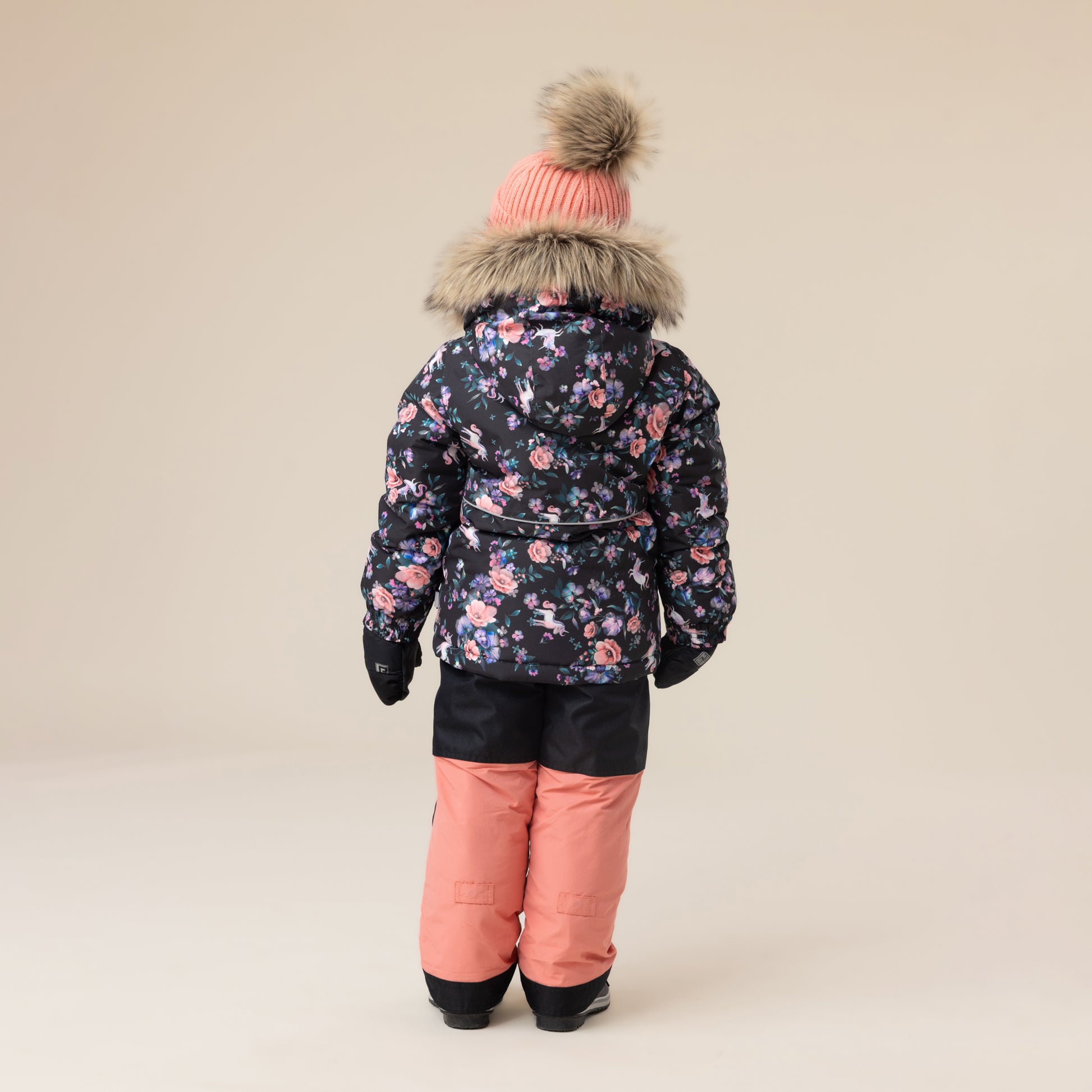 Habit de neige - Peluche & Tartine pour enfant avec veste noire à motifs floraux roses et bleus, pantalon saumon, vue de dos.