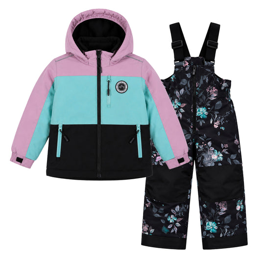 Habit de neige - Peluche & Tartine pour enfant, veste color block rose, turquoise et noir avec pantalon à bretelles noir à motifs floraux, vue de face.