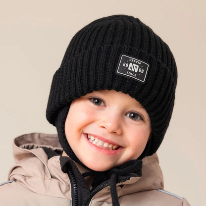 Tuque d'hiver - Nanö noire en tricot côtelé, portée par un enfant, vue de face