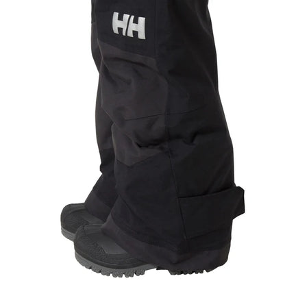 Salopette de neige Rider - Helly Hansen noire avec guêtres intégrées et renforts aux chevilles vue de détail
