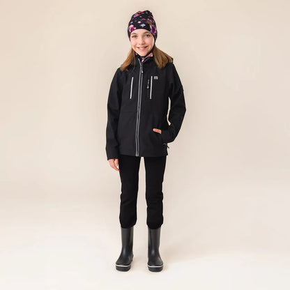 Manteau Mi-Saison Softshell - Nanö noir en softshell pour enfant fille, porté sur mannequin, vue de face complète.