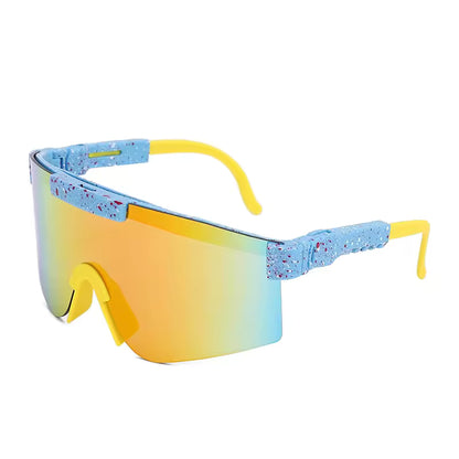Lunettes de soleil - Kids Windshield avec verre irisé orange et bleu, monture bleue mouchetée, branches jaunes, style enfant, vue de côté.