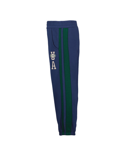 Pantalon - Under Armour bleu marine à bandes latérales vertes, taille et chevilles élastiquées, vue de face pour enfant