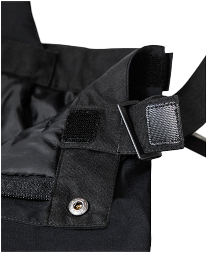 Salopette de neige - Under Armour noire, détail de la bretelle réglable et de la boucle de fixation, vue rapprochée