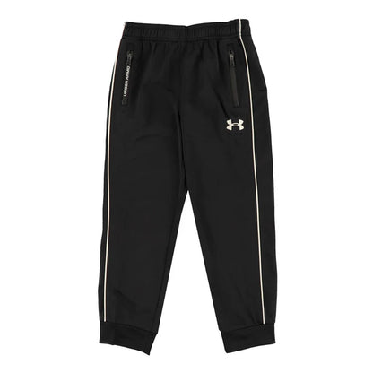 Pantalon - Under Armour noir avec bandes blanches latérales, poches zippées, tissu technique, pour enfant, vue de face.