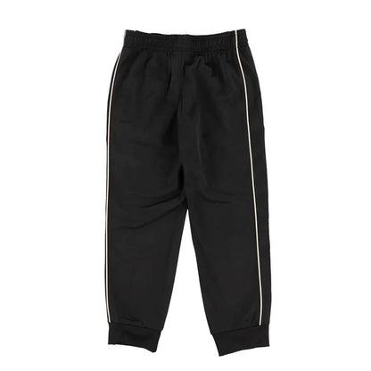Pantalon - Under Armour noir avec bandes latérales blanches, coupe droite, tissu en matière technique, vue de face.