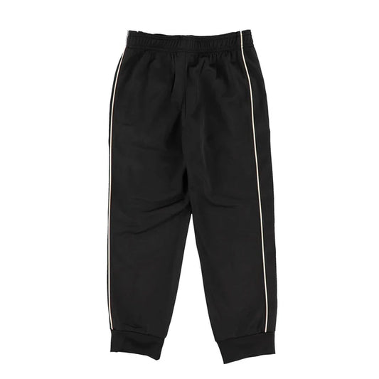 Pantalon - Under Armour noir avec bandes latérales blanches, coupe droite, tissu en matière technique, vue de face.