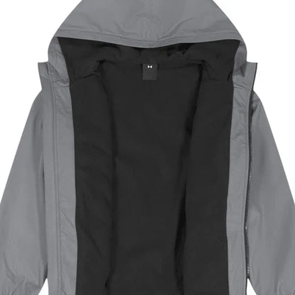 Manteau Mi-Saison - Under Armour gris avec intérieur noir et capuche, conçu pour confort et protection légère.
