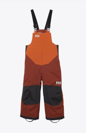 Salopette de neige Rider - Helly Hansen, bicolore orange et marron avec renforts noirs aux genoux, style technique, vue de face, vêtement enfant.