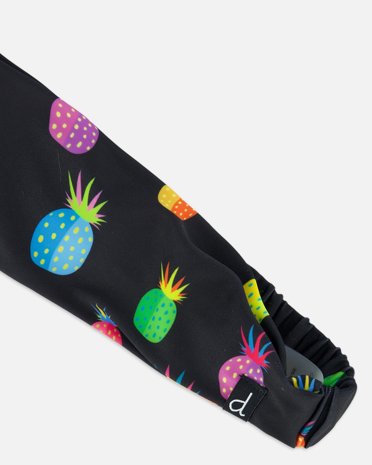 Bandeau - Deux Par Deux noir avec imprimé d'ananas multicolores, en polyester recyclé, pour fille, détail tissu et élastique arrière.