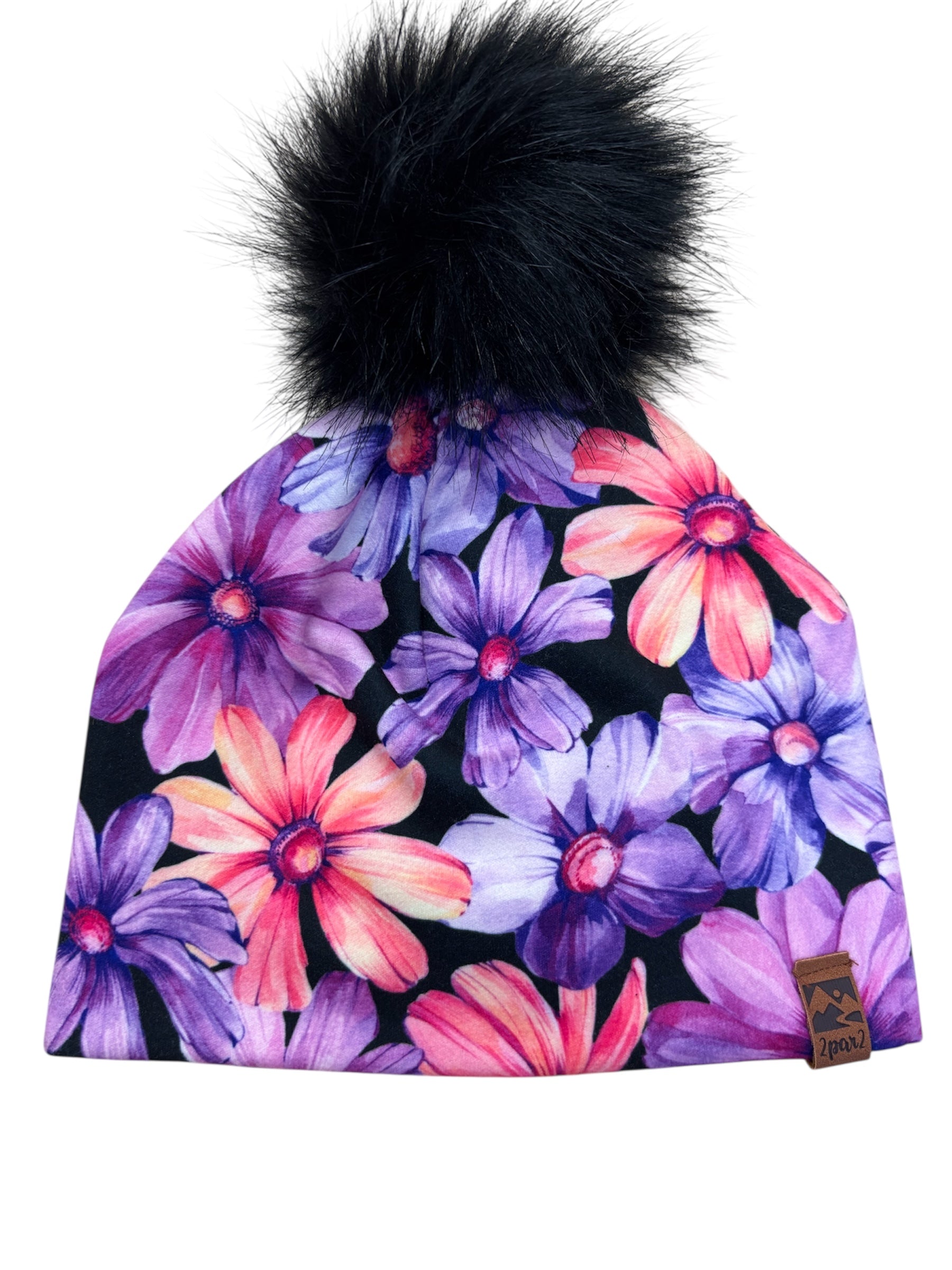 Tuque Mi-Saison - Deux Par Deux en jersey doux à fleurs violettes et roses avec pompon noir, pour fille, vue de face.