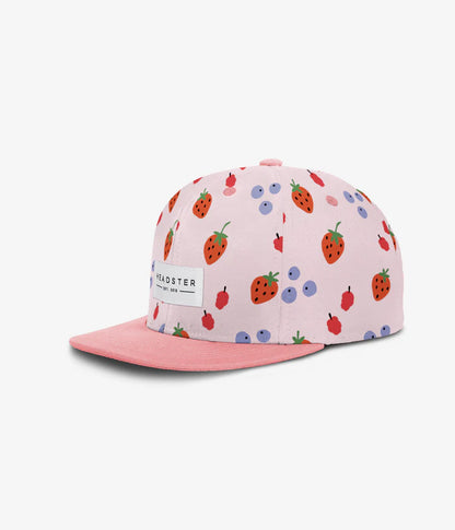 Casquette - Headster rose clair à motifs fraises et cerises rouges, visière rose uni, pour fille enfant, vue de profil gauche.