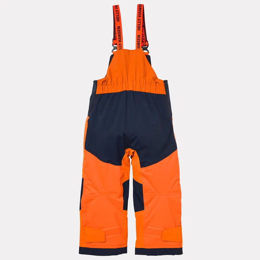Salopette de neige - Helly Hansen orange fluo et bleu marine, bretelles élastiques réglables, vue de dos enfant.