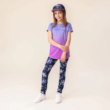Fille portant une Casquette - Nanö noire à motifs floraux violets, vue de face, style casual enfant, tissu coton.