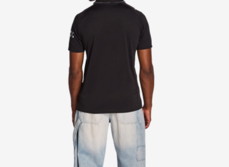 Polo Manchester - Puma noir en polyester pour garçon, manches courtes, vue de dos porté sur mannequin.