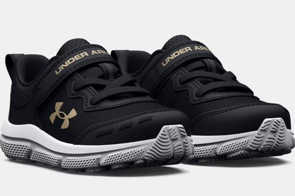 Espadrilles UA Assert 10 AC - Under Armour noires avec détails dorés, tige mesh, scratch, semelle blanche, vue de profil avant enfant.