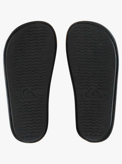Sandales - Quiksilver semelles noires en caoutchouc avec logo, vue de dessous, style flip flop pour adulte.